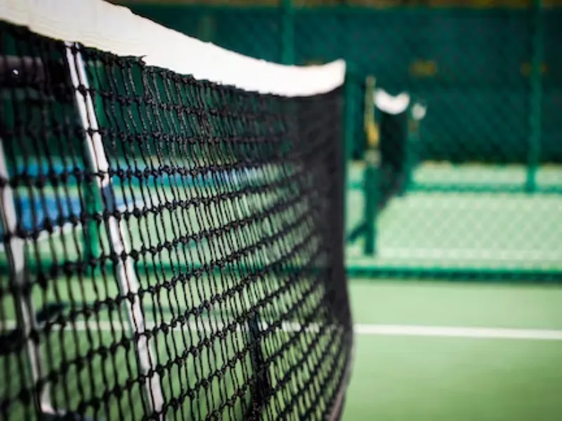 A closeup shot of a pickleball net, highlighting equipment used for how to improve your pickleball game.